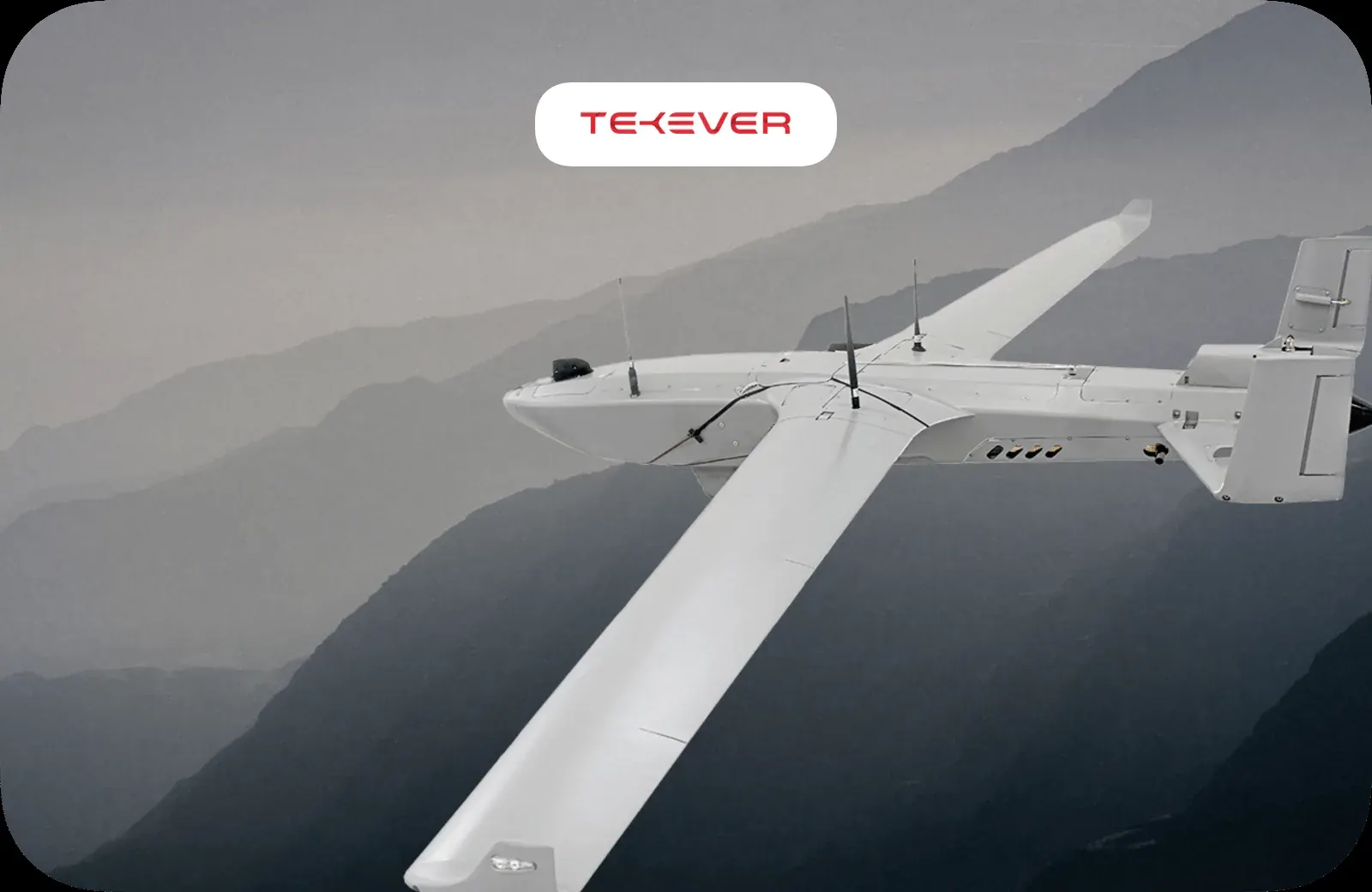 A Tekever autonomous aircraft in flight over mountains