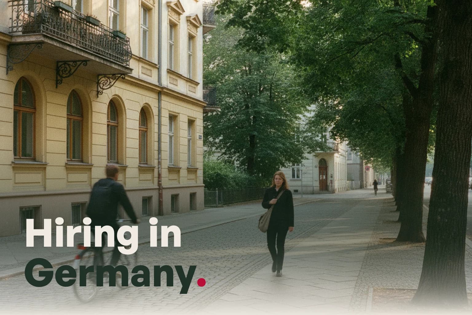 A Berlin street of Altbau apartments with a cyclist and a woman walking, with the line Hiring in Germany.