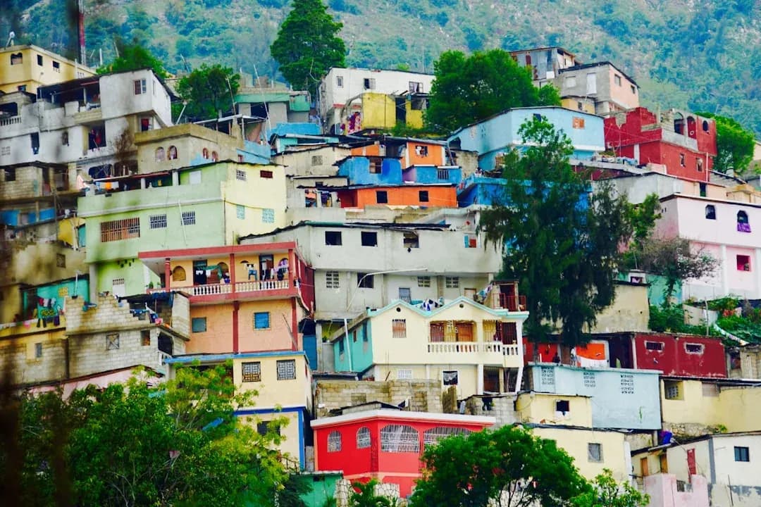 Colourful gingerbread houses and bougainvillea lining a sunlit street in the Pacot district of Port-au-Prince, Haiti