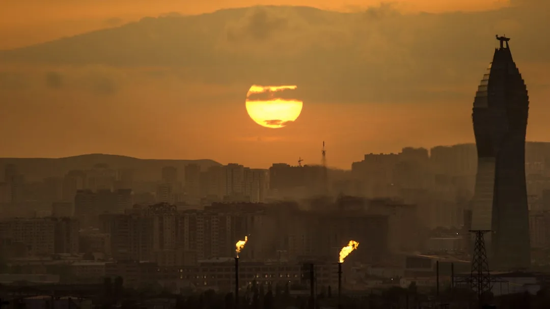 A warm illustration of Beirut at sunset: the Mediterranean coastline along the Corniche, low pink light over the city, and the hills behind the harbour.
