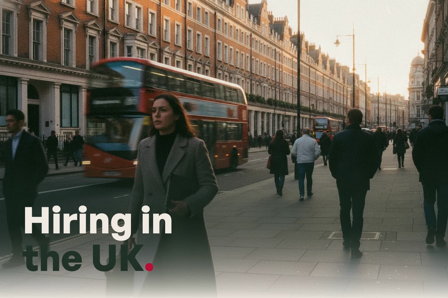A London street in late afternoon light, a bus passing and people walking, with the line Hiring in the UK.