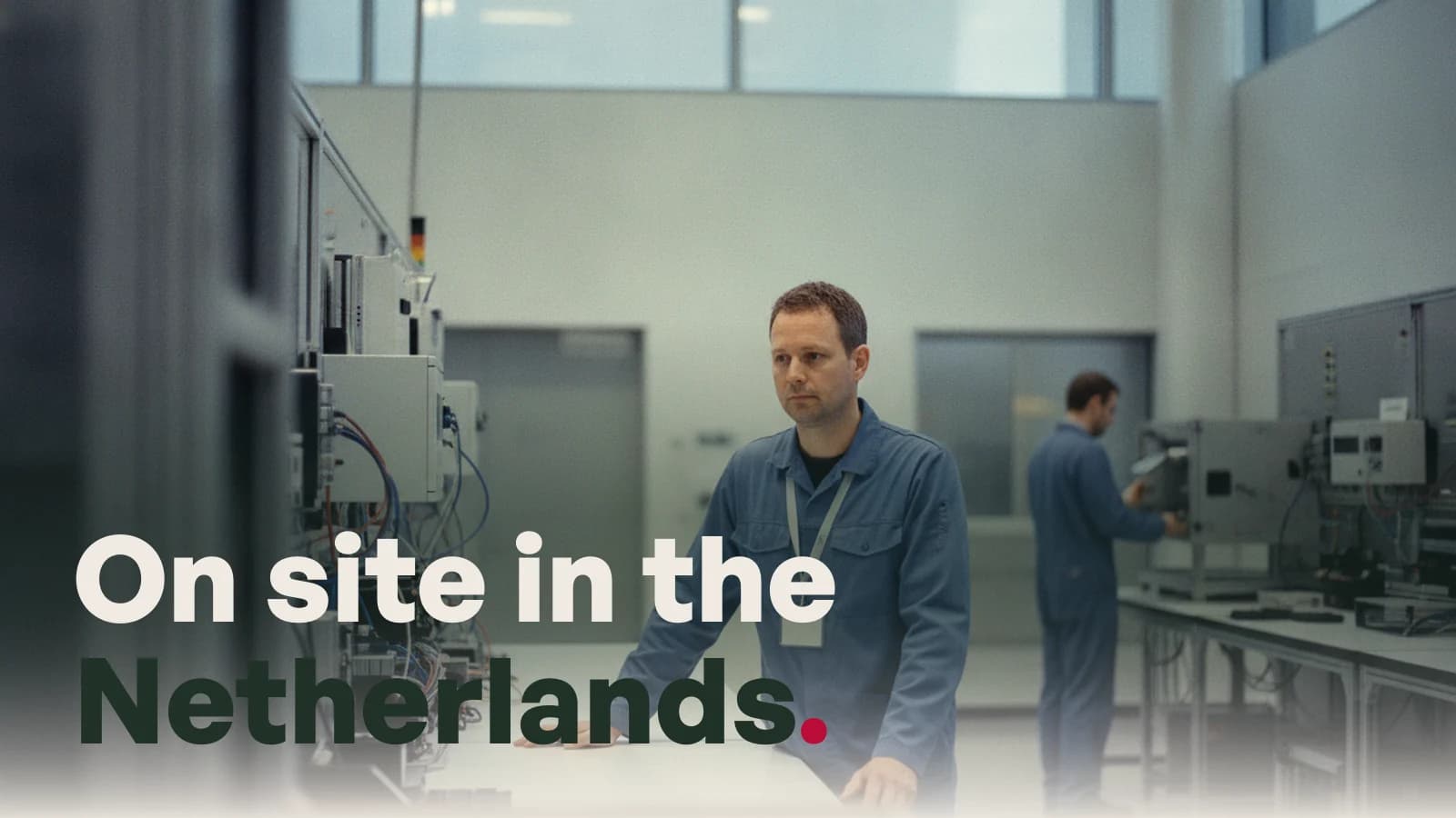 An engineer at a workbench in a Dutch technology facility, with the line On site in the Netherlands.