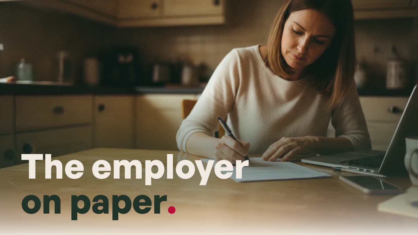A woman signing a printed contract at a wooden kitchen table in soft daylight, a laptop open beside her, with the line The employer on paper.