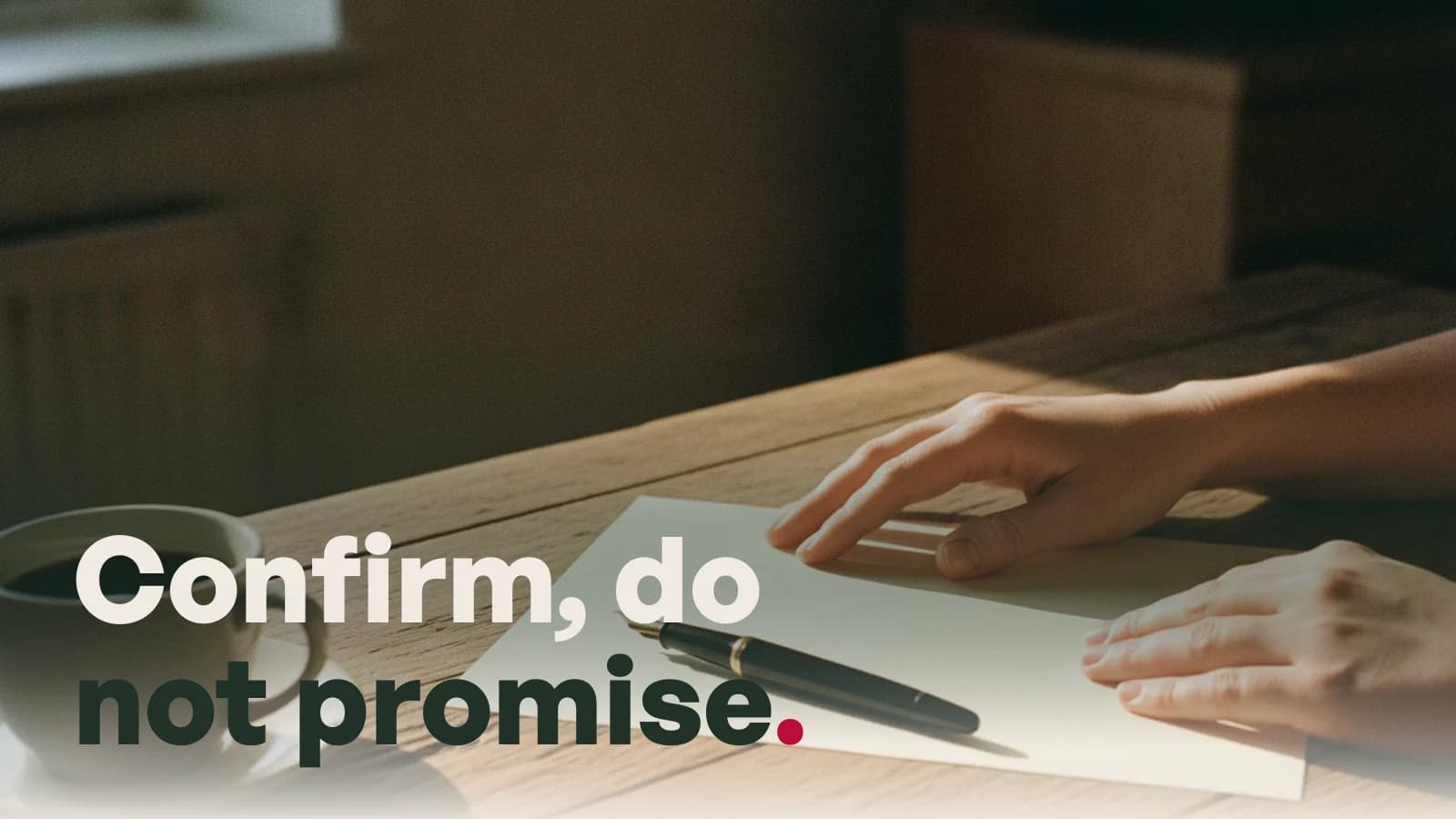Hands resting on a desk beside a blank sheet of paper and a pen, with the line Confirm, do not promise.