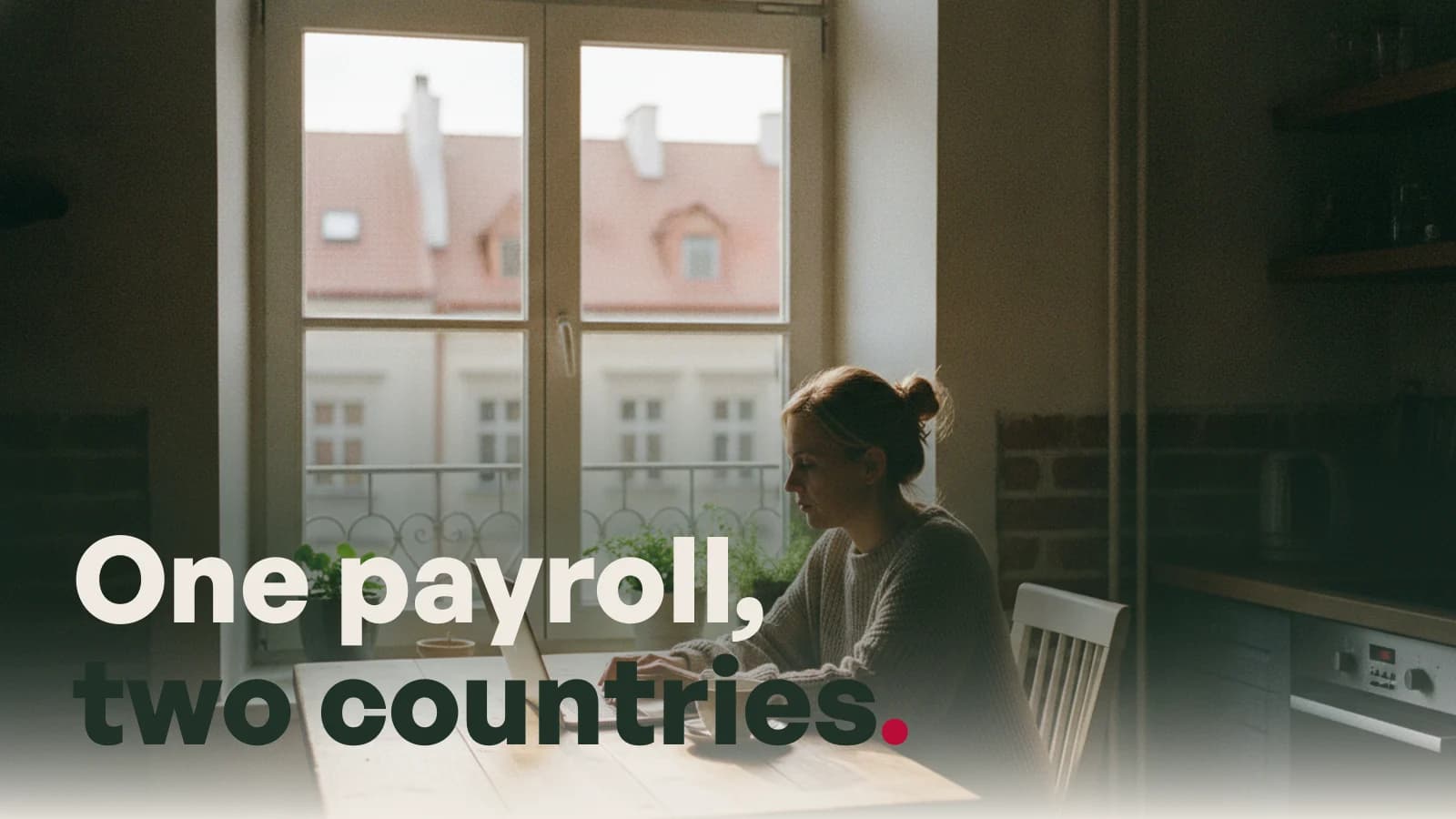 A woman working at a kitchen table in an apartment abroad, captioned One payroll, two countries.