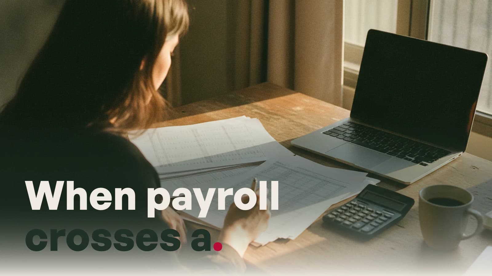 Someone checking printed payroll sheets at a desk, captioned When payroll crosses a border.
