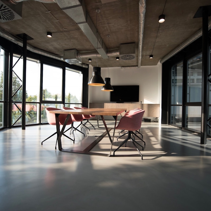 A modern coworking space in Berlin, a developer at a standing desk with a second monitor.