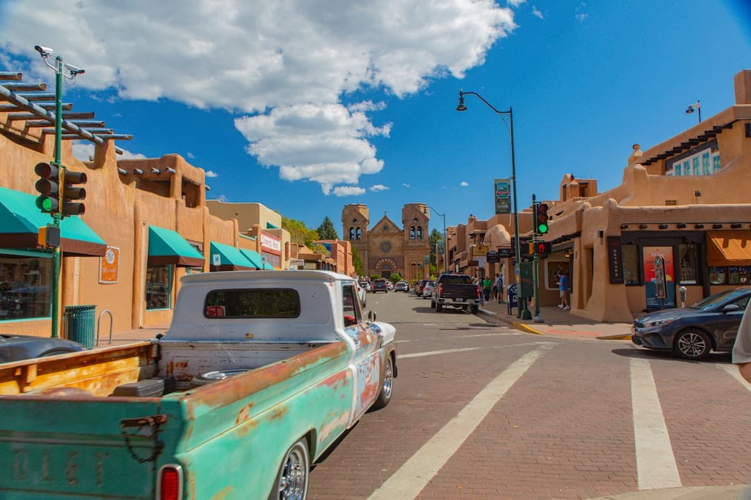 Santa Fe, New Mexico, historic downtown plaza with adobe buildings and a clear blue sky.