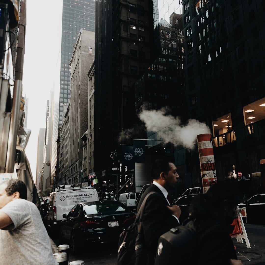 People walking through a New York City canyon of glass towers, morning commute