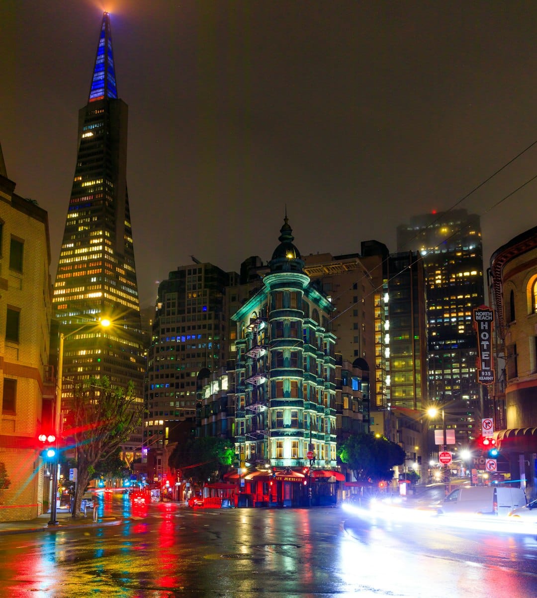 City street at night with wet pavement reflecting amber streetlights, Pennsylvania urban scene