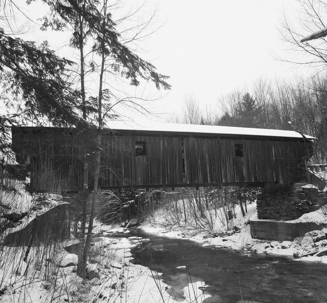 A historic Vermont covered bridge surrounded by autumn foliage, Grafton, Vermont.