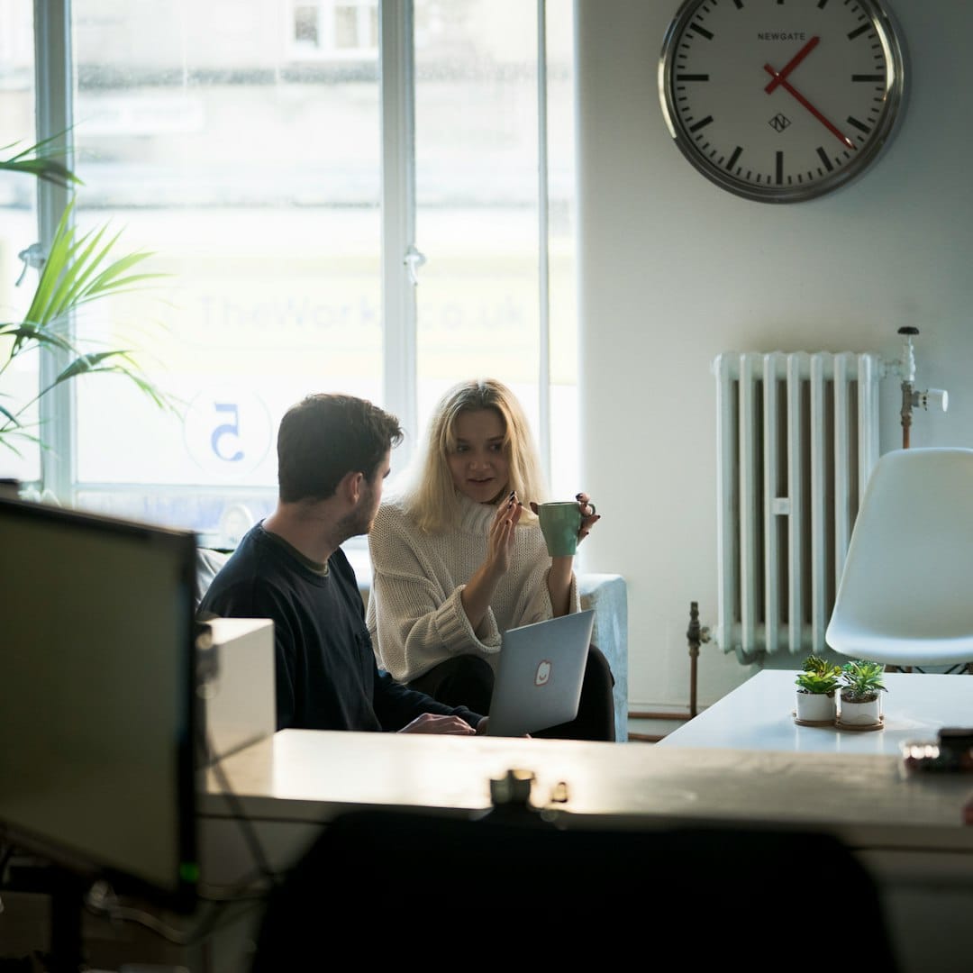 People working at laptops in a coworking space, representing flexible contractor arrangements