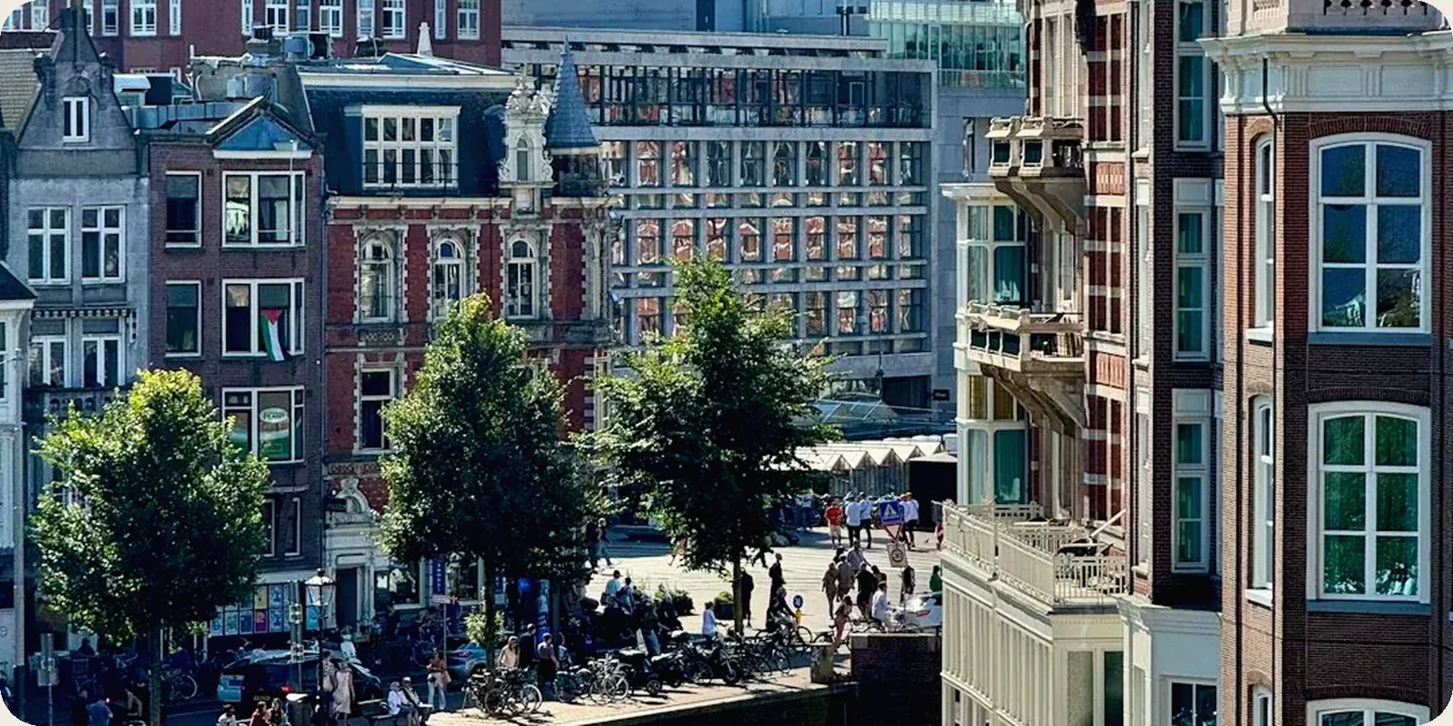 A Dutch canal street with gabled houses in afternoon light.