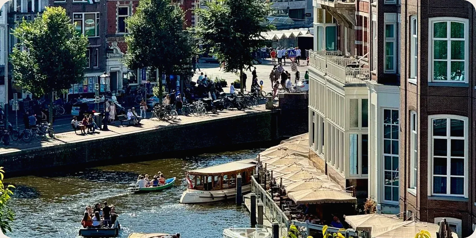 A Dutch canal scene with bicycles and gabled houses.