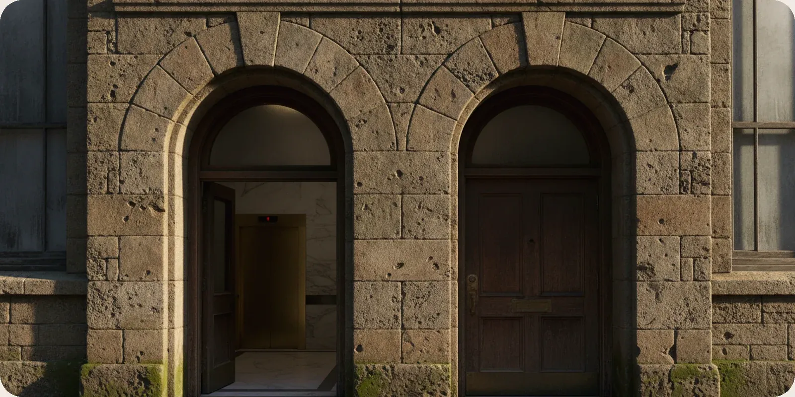 Two doorways side by side on an American office building, one open and one closed.