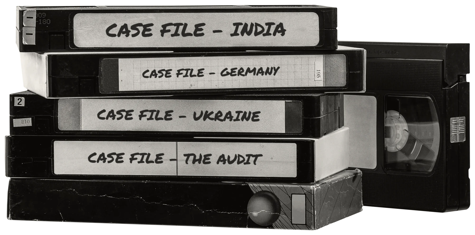 A stack of VHS tapes, their spines hand-labelled with Teamed case files: India, Germany, Ukraine and The Audit.