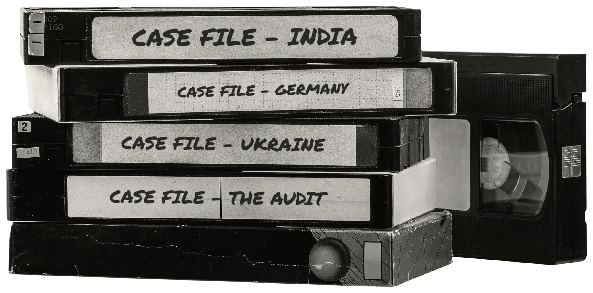 A stack of VHS tapes, their spines hand-labelled with Teamed case files: India, Germany, Ukraine and The Audit.