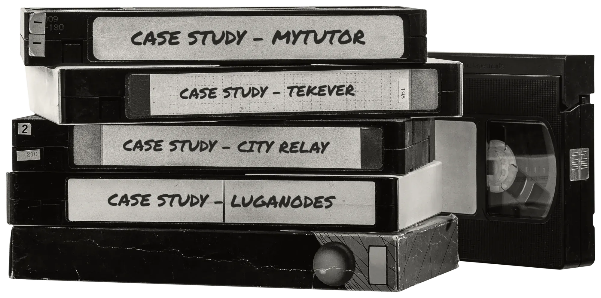 A stack of VHS tapes, their spines hand-labelled with Teamed case studies: MyTutor, Tekever, City Relay and Luganodes.