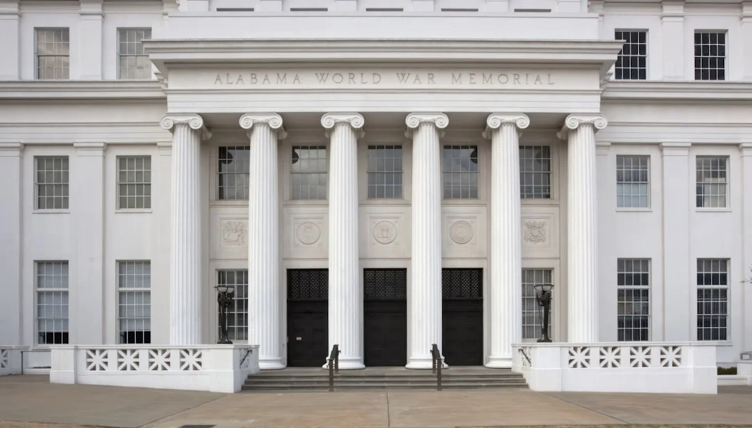 Alabama Archives and History Museum exterior in Montgomery, classical limestone facade under bright sky.