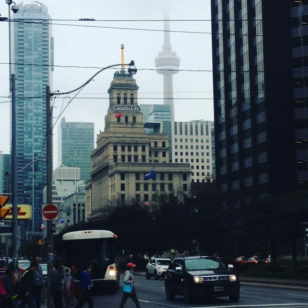 A view across Toronto's financial district toward the CN Tower on a clear day.