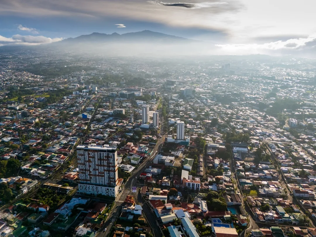 San Jose, Costa Rica skyline at golden hour with the green Talamanca mountains rising behind the city centre.