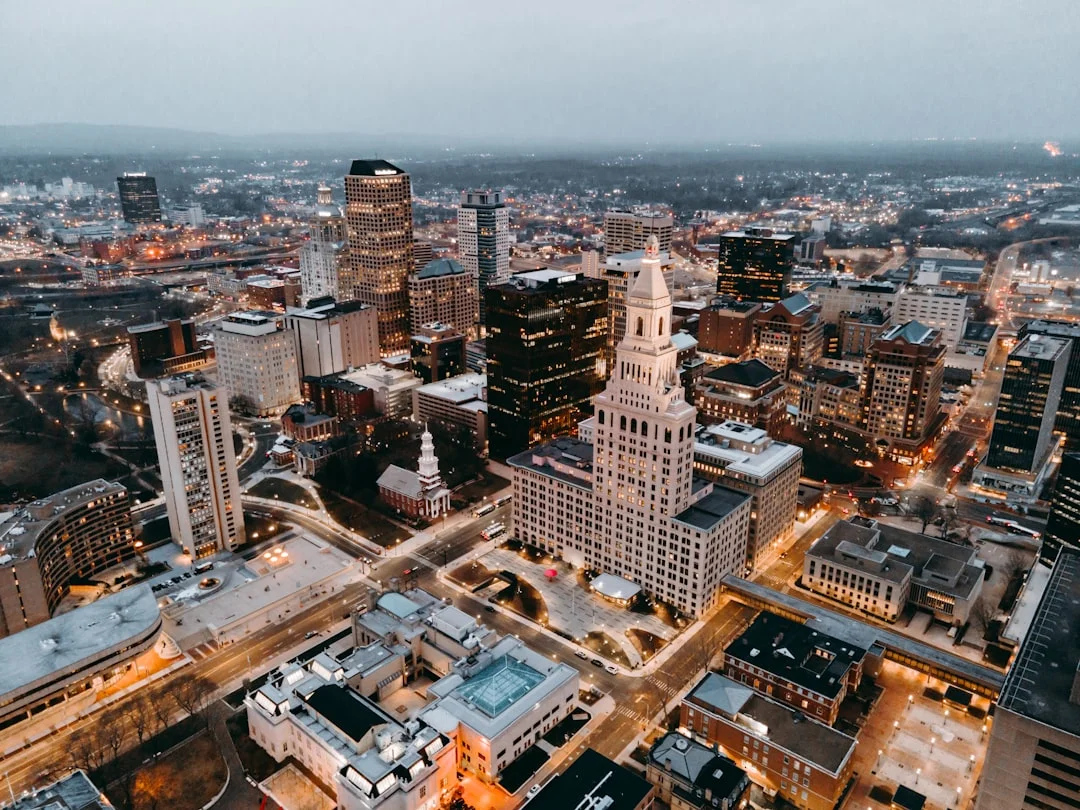 Aerial daytime view of Hartford, Connecticut showing downtown buildings along the Connecticut River.