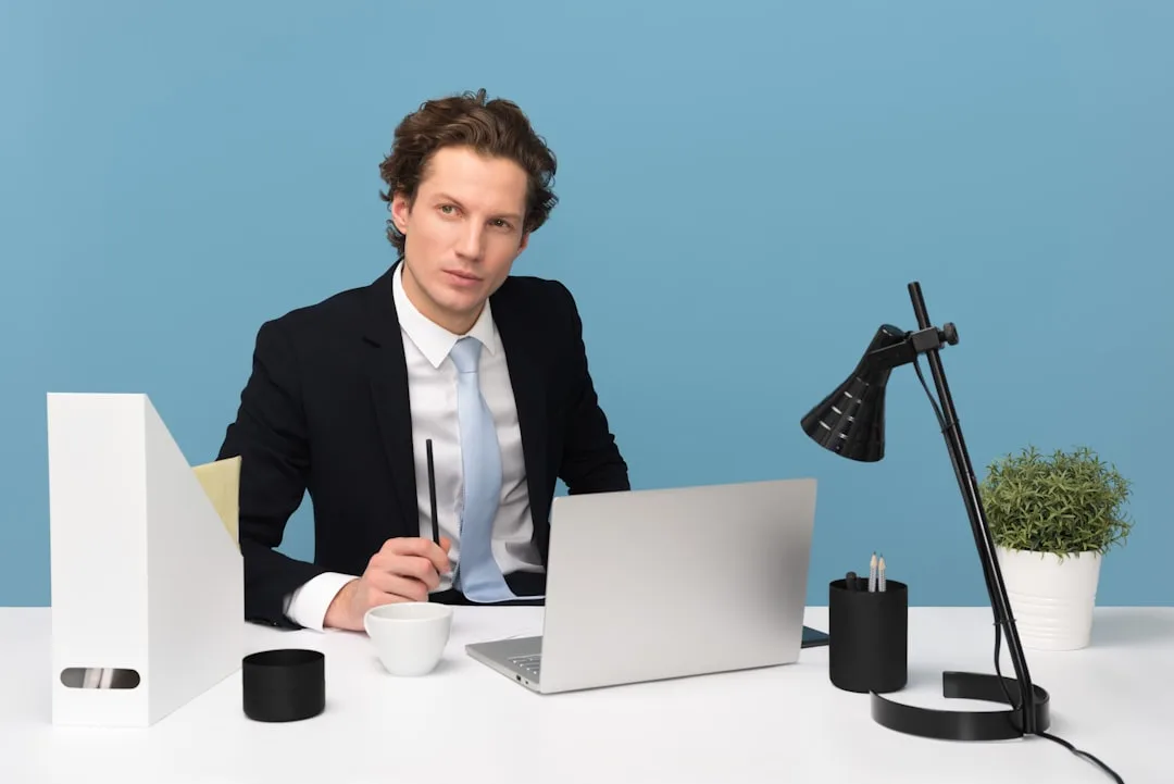 A payroll specialist reviewing a Finnish salary slip at a bright desk beside a cup of coffee.