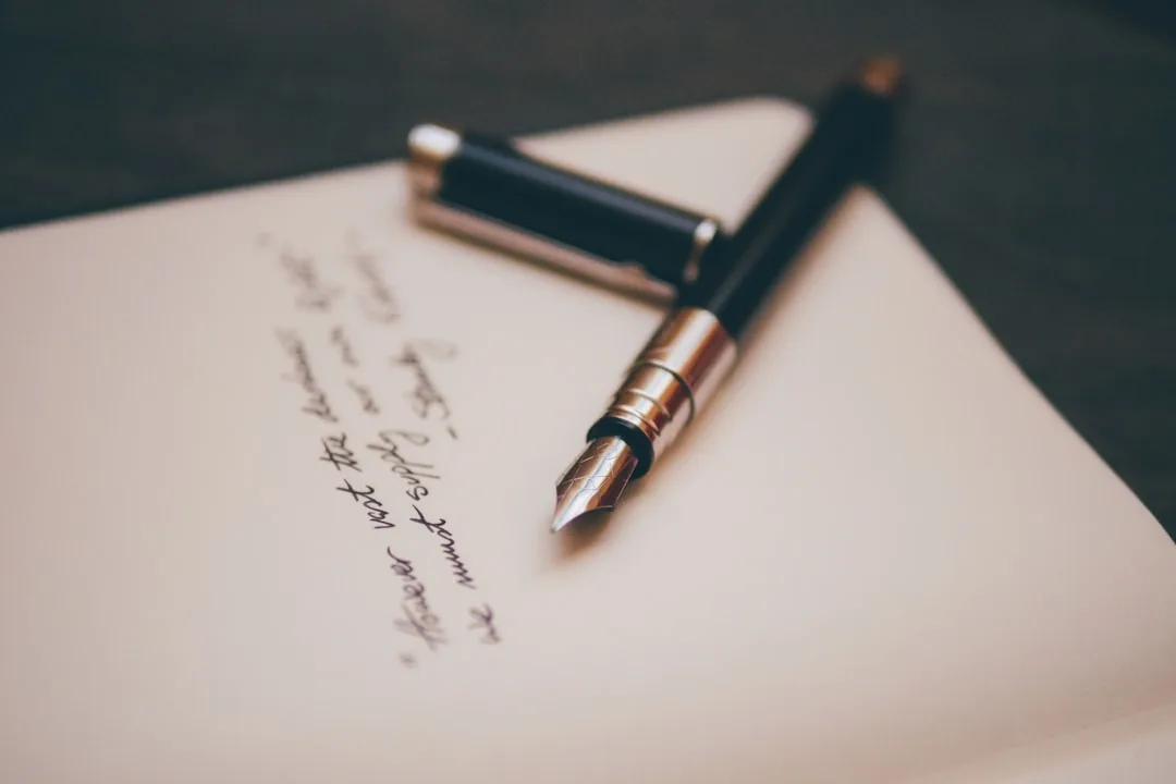 A tidy desk with a signed letter, a fountain pen and a coffee cup in a bright Helsinki office.