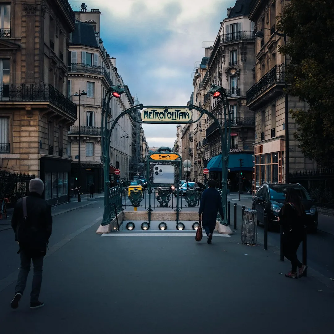 A classic French wrought-iron balcony overlooking a quiet Paris street.