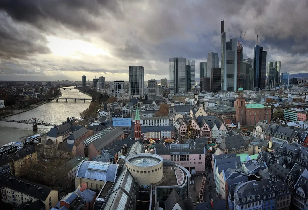 A formal meeting room in a German office building, with large windows overlooking a city skyline.