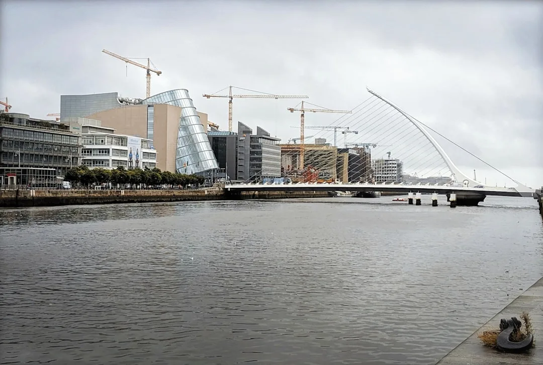 Dublin city view along the River Liffey with Georgian architecture and a clear blue sky.
