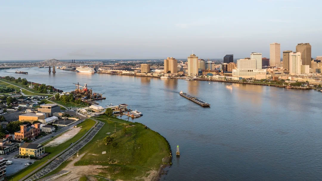 New Orleans cityscape with the Mississippi River and downtown buildings at dusk, Louisiana.