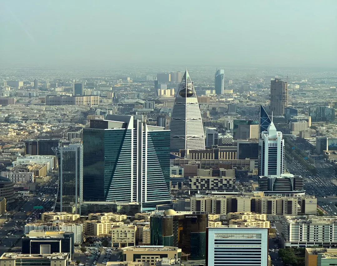 Riyadh skyline at golden hour with the Kingdom Tower catching the last light.
