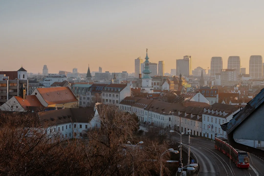 Bratislava old town at golden hour, the castle on the hill above the Danube and pastel townhouses below.