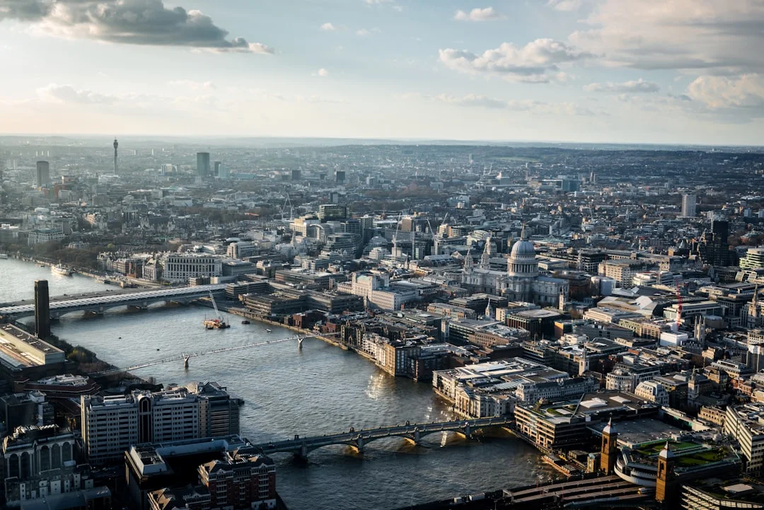 A wide London cityscape with the Thames and central buildings.