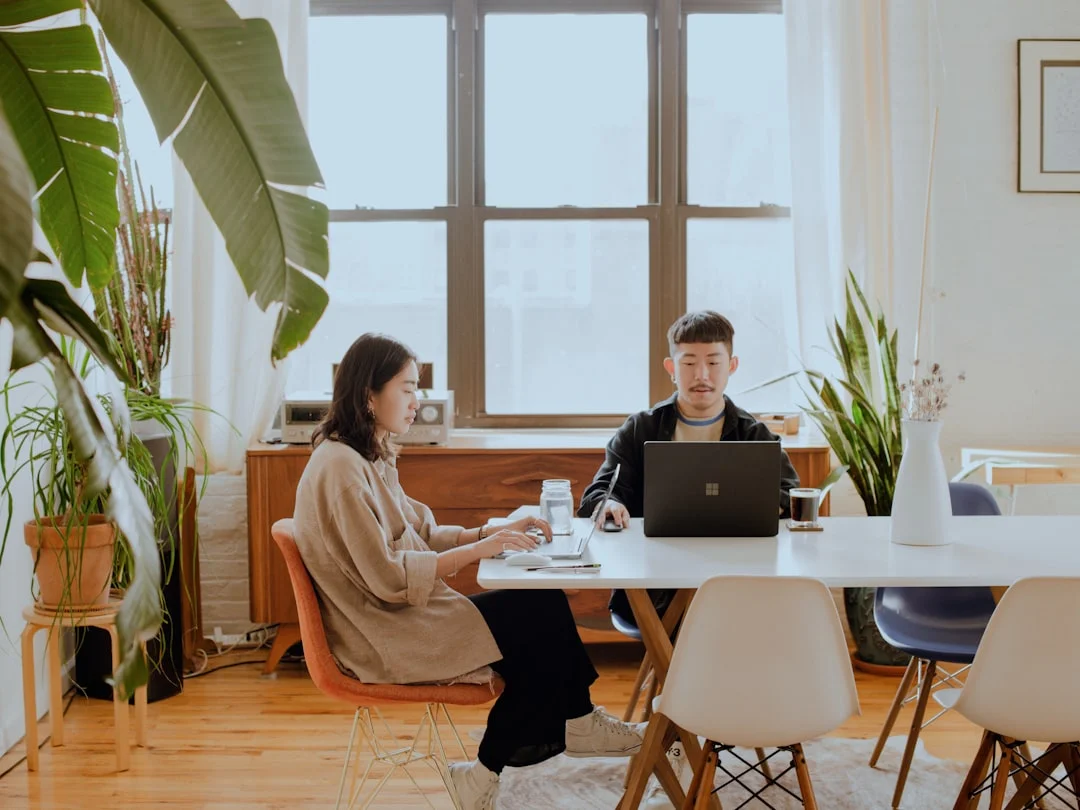 A contractor freelancer working at a desk with documents and a laptop.